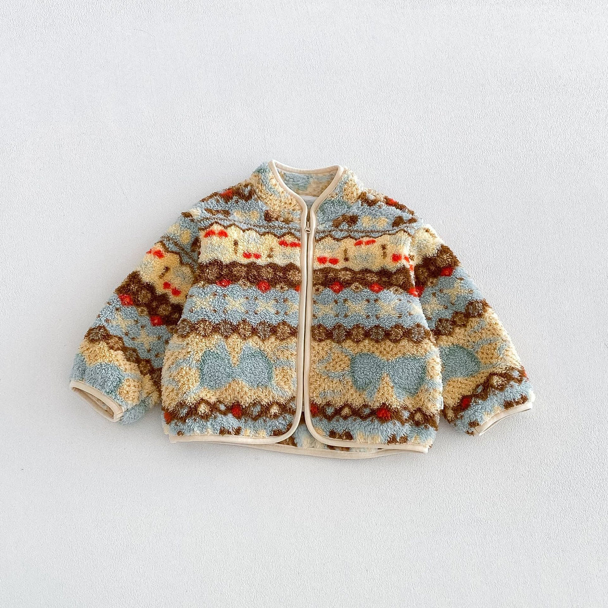 Butter yellow folk pattern fleece zip jacket with hearts and cherries, flat lay