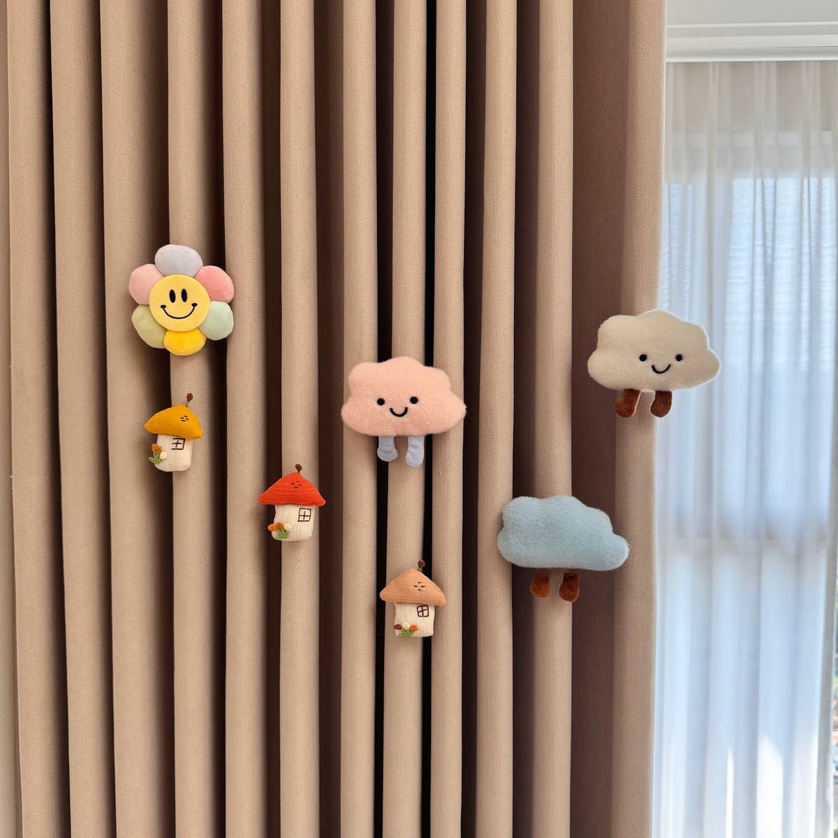 Cloud garden set with smiling flower, clouds and little houses pinned to a curtain