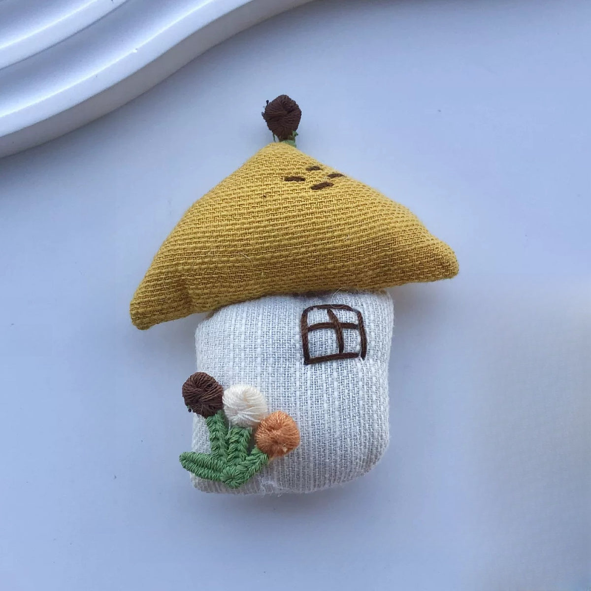 Little house fabric pin with mustard roof and embroidered flowers