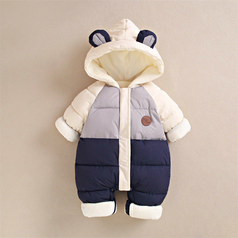 Chic color-blocked baby romper featuring cream, grey, and navy shades with a cozy hood adorned with bear ears. This puffer-style romper is crafted to keep babies warm, complete with a soft fleece lining, fold-over mittens, and footed legs for added comfort and protection against cold weather.