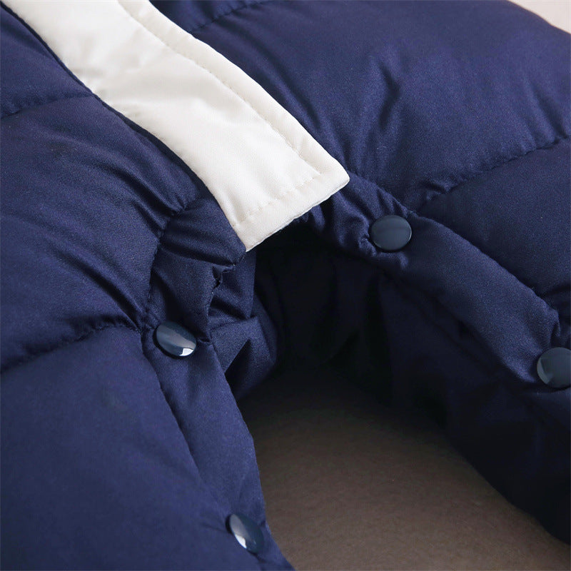 Close-up view of the leg snap closures on a navy blue baby romper, featuring dark blue snap buttons and a contrasting white fabric trim along the edge. The snap closures provide easy access for diaper changes.