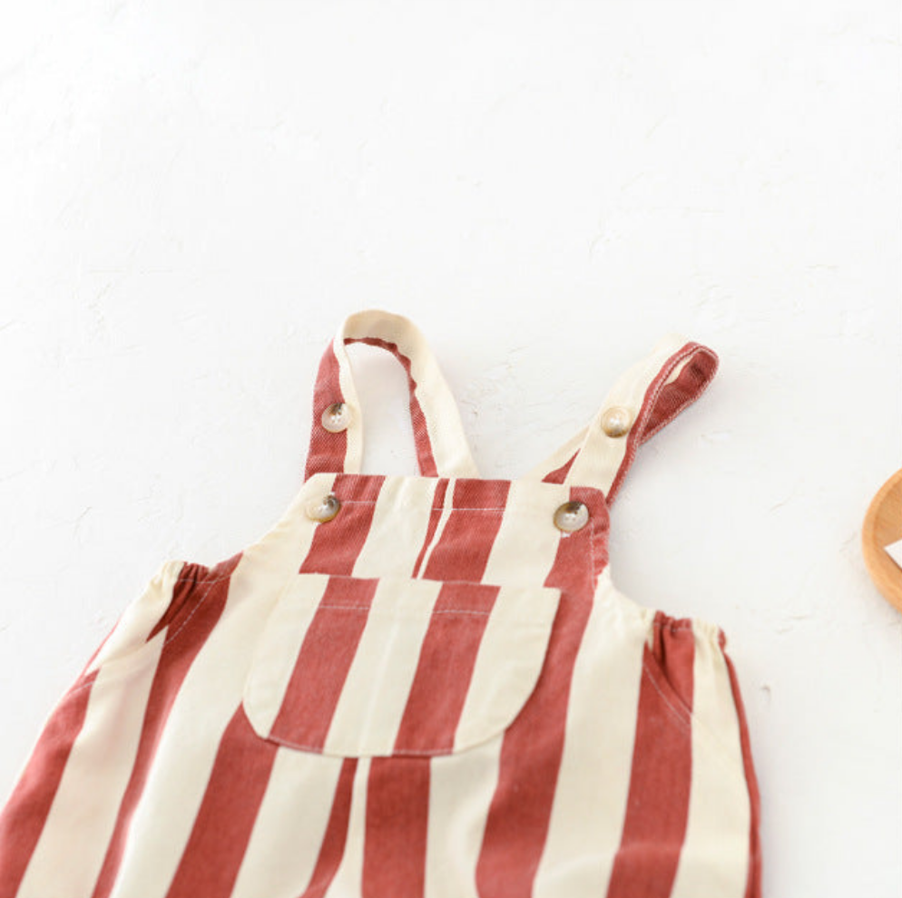 Striped baby overall bib front pocket and button strap closure detail