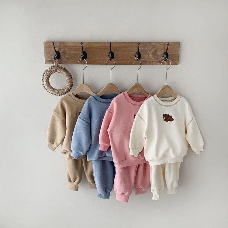 Cozy toddler sweater and pants set in soft pastel colors, featuring a cute bear print on the cream set. Available in beige, blue, pink, and cream, these comfortable two-piece outfits are perfect for fall and winter wear, keeping your little ones warm and stylish. Ideal for casual outings and everyday playtime.