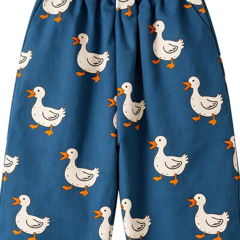 Close-up of white ducks on blue kids pants