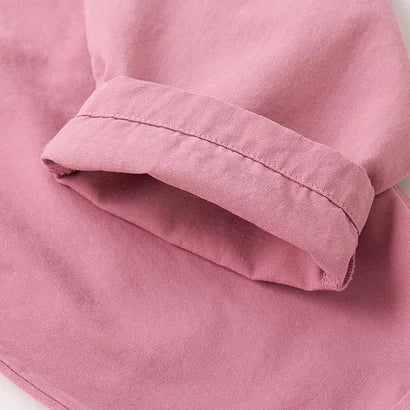Rolled cuff detail on pink cotton overalls