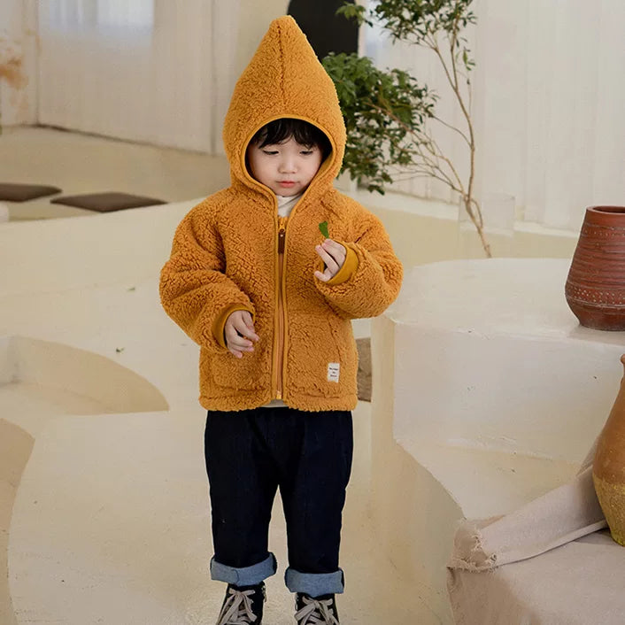 Toddler in a mustard sherpa jacket with pointed gnome hood