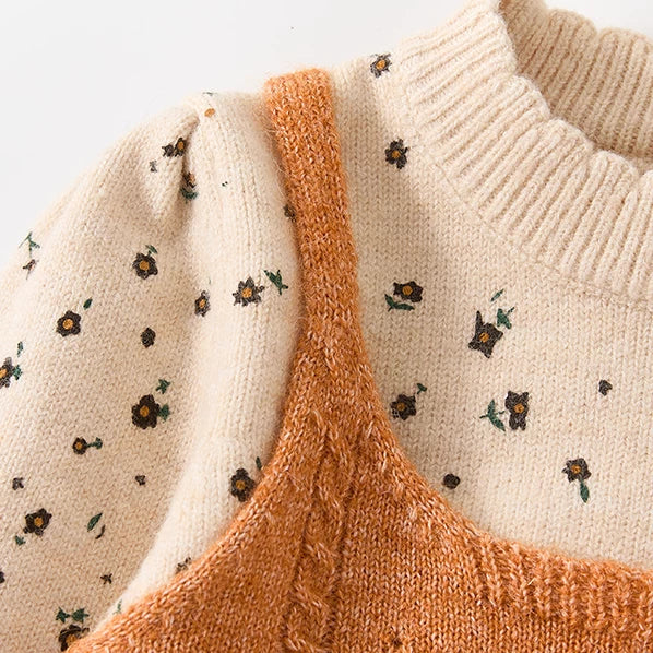 Close-up of the soft crew neck and floral knit on a girls sweater