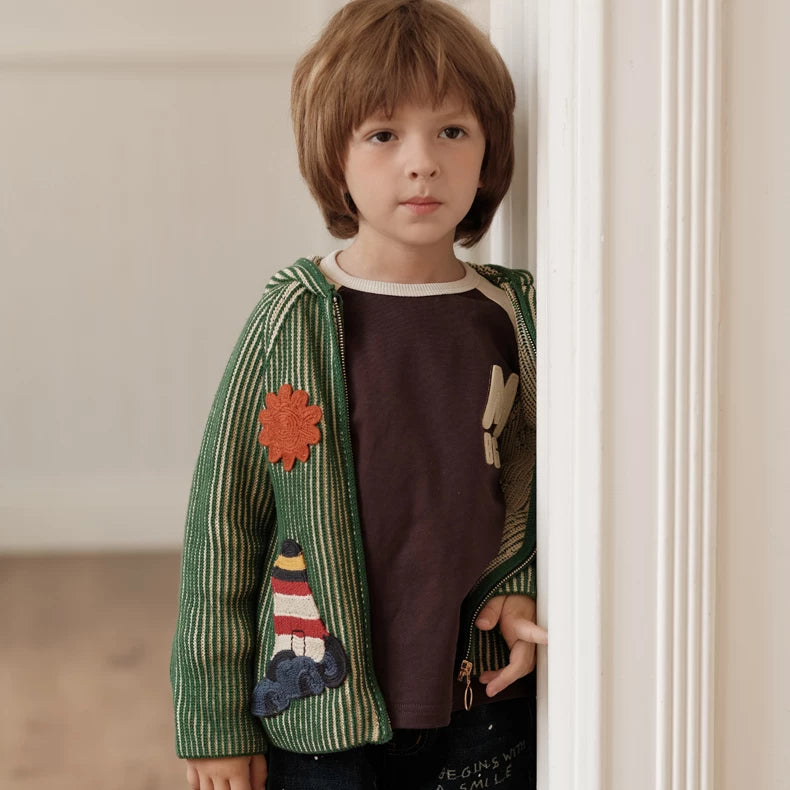Kids green knit cardigan worn open over a brown tee