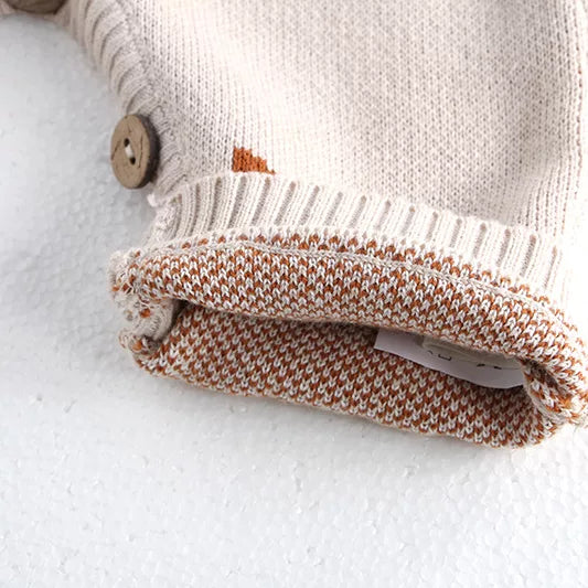 Inside of fox knit overalls showing the soft woven-pattern lining side
