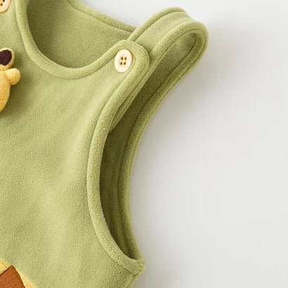 Plush giraffe appliqué and shoulder button on the pistachio romper