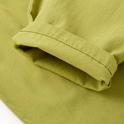 Rolled cuff detail on green cotton overalls