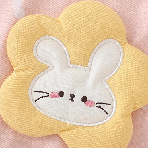 Close-up of the padded yellow flower and embroidered bunny face