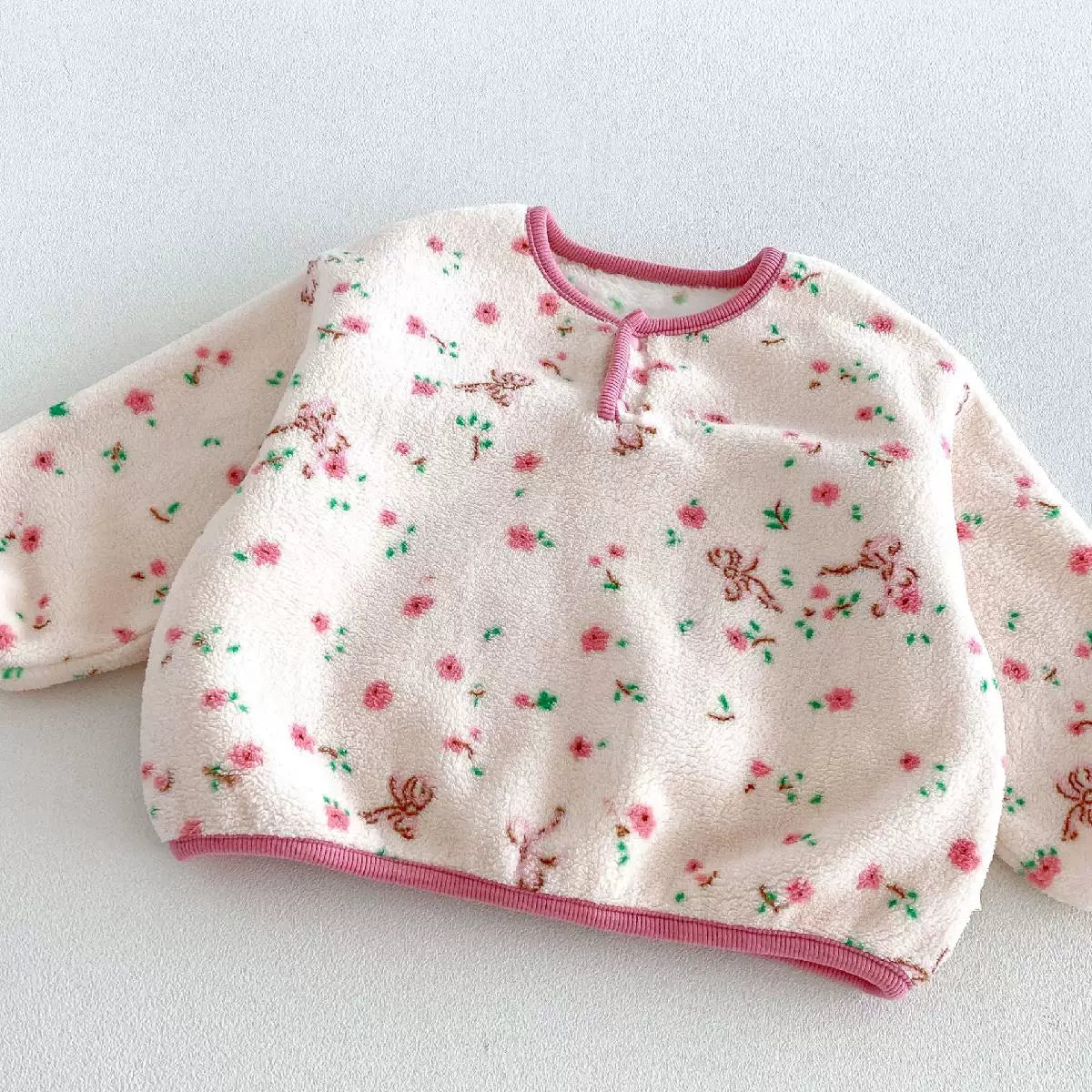 Henley neckline with pink piping on floral fleece pajama top