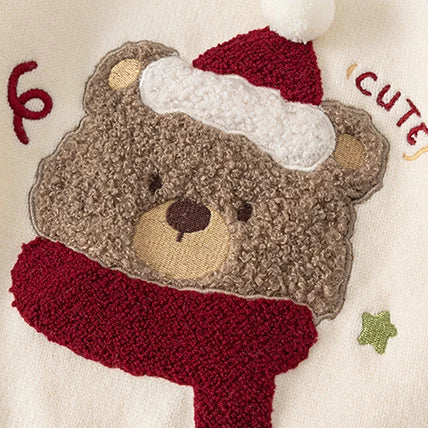 Close-up of the fluffy bear appliqué with Santa hat and red scarf