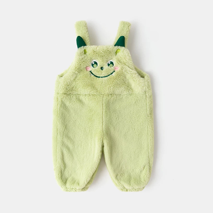 Pistachio green plush kids overalls with an embroidered monster face, flat lay