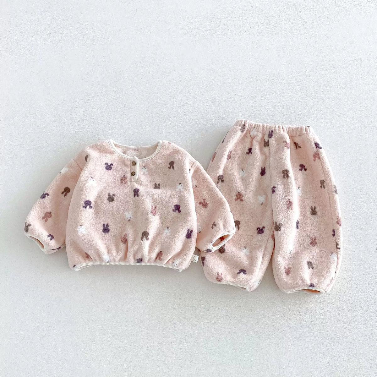 Pink bunny print plush fleece pajama set, flat lay