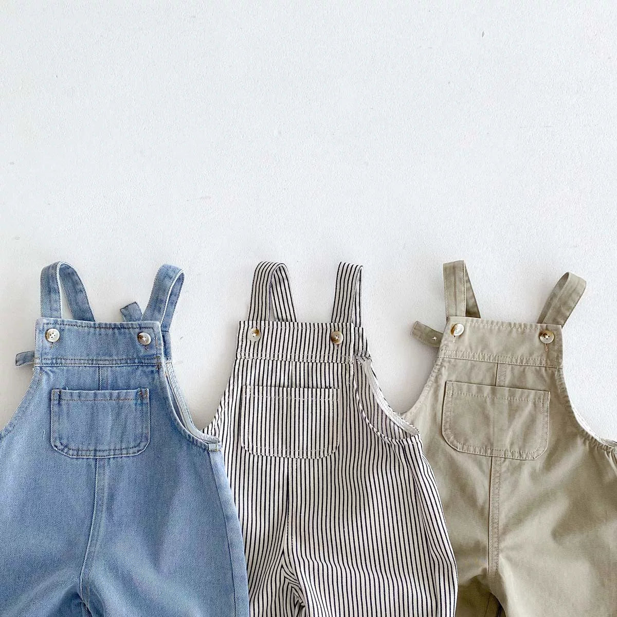 Bib pockets and adjustable buckle straps on denim, striped and khaki overalls