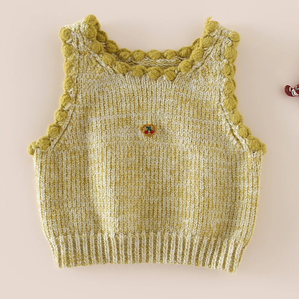 Matcha green knit sweater vest with bobble trim and cherry heart embroidery, flat lay