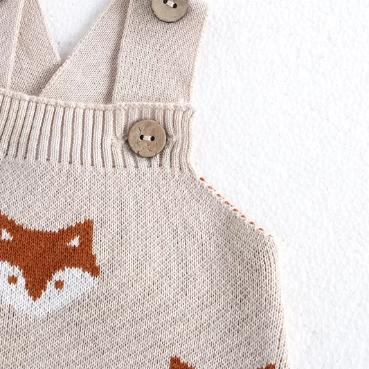 Close-up of the fox motif and ribbed bib on knitted baby overalls