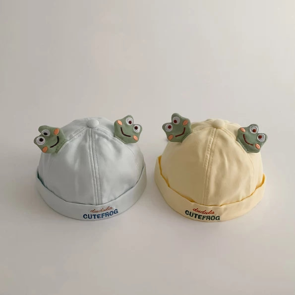Sky blue and butter yellow frog baby hats side by side