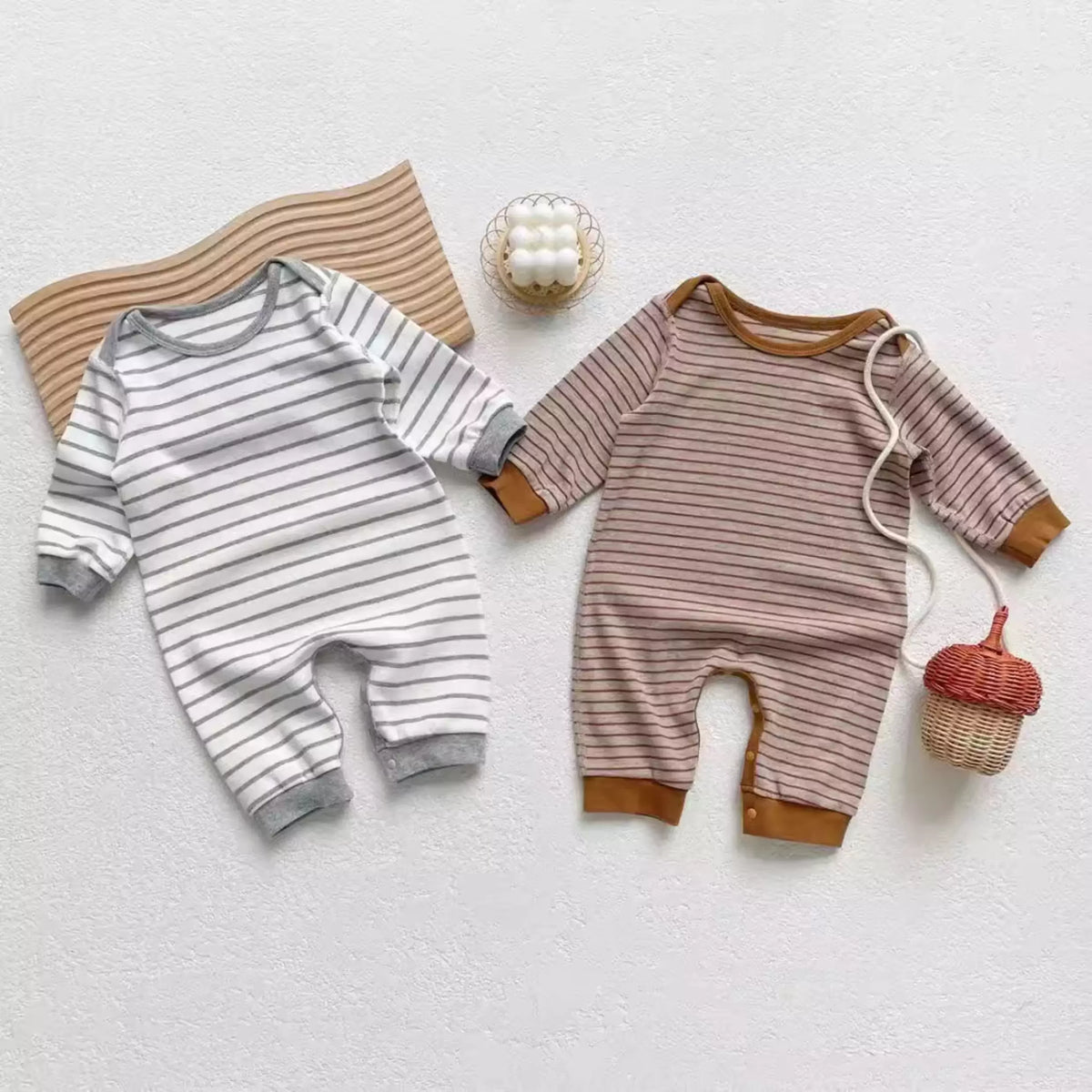 Grey and mocha striped cotton rompers styled with wooden toys