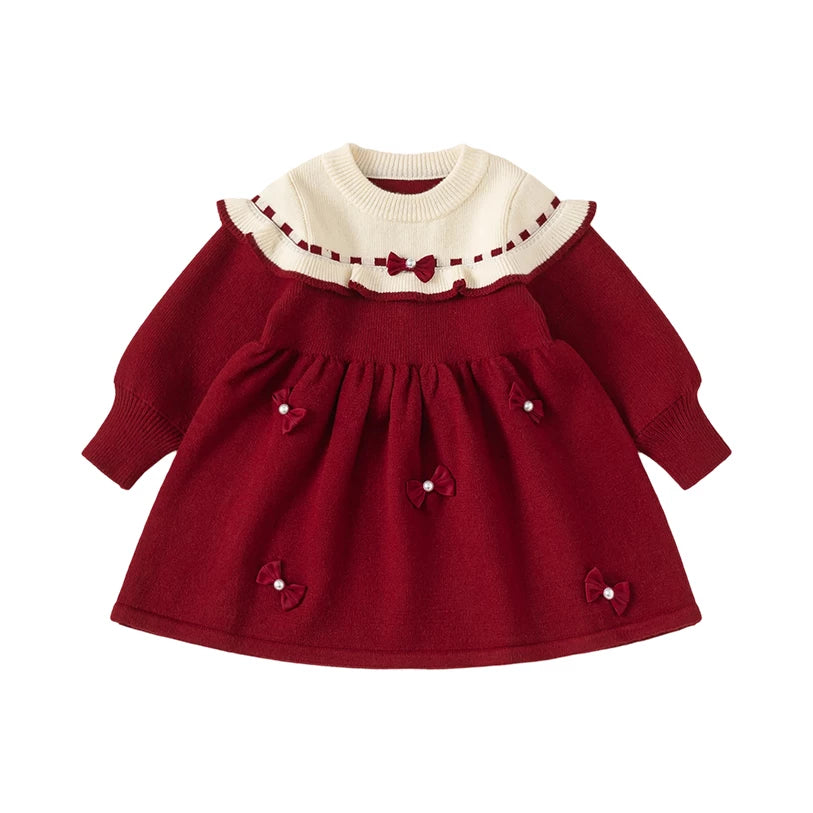 Red knit girls sweater dress with cream ruffle collar and pearl bows, flat lay