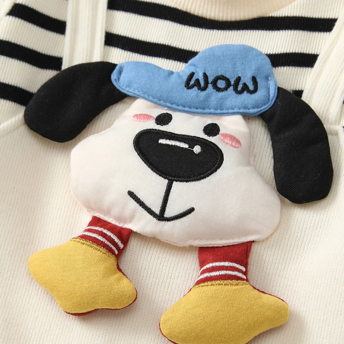 Close-up of the 3D puppy appliqué with blue WOW cap and dangling legs