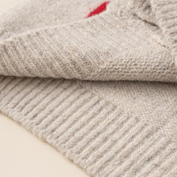 Ribbed hem detail on oatmeal knit cardigan