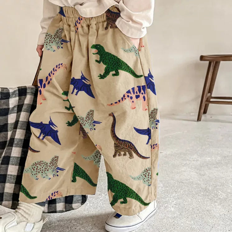 Child in khaki dinosaur print pants with elastic waist
