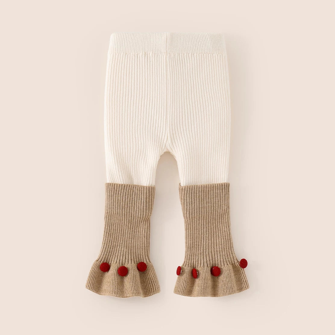 Cream ribbed knit leggings with camel flared cuffs and red pom-poms, flat lay