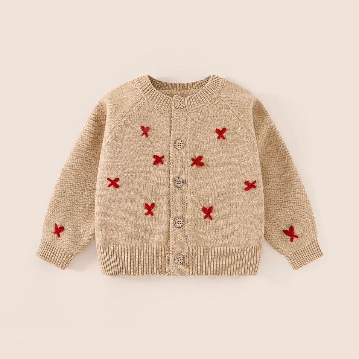Camel button-front knit cardigan with red cross-stitch embroidery, flat lay