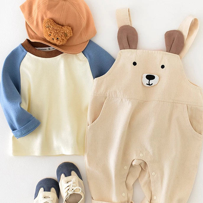 Bear overalls and cream raglan tee laid side by side