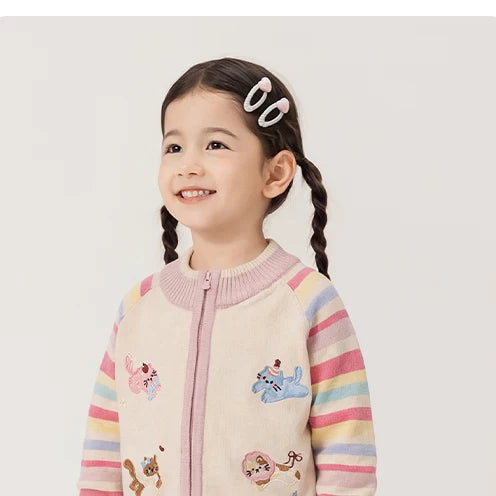 Smiling toddler girl in the rose rainbow zip cardigan