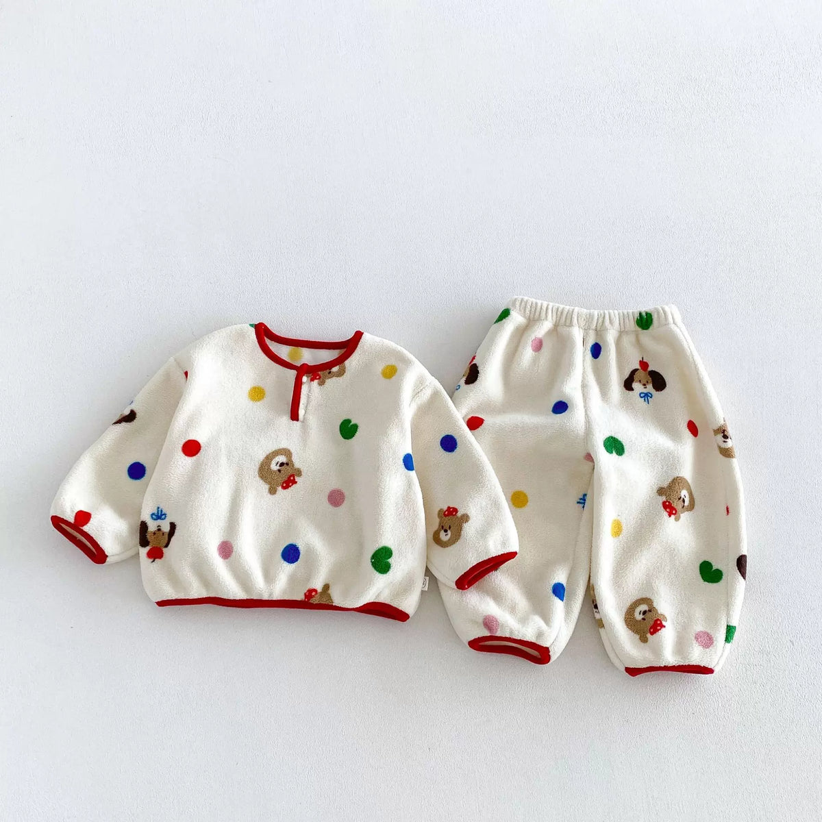 Cream plush fleece girls pajama set with confetti dots and bears, flat lay