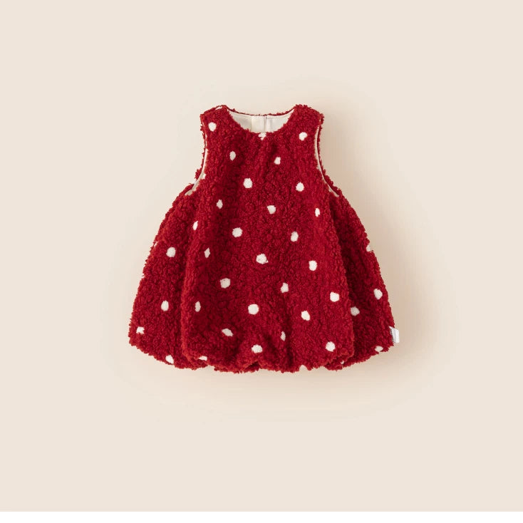 Red teddy fleece pinafore dress with white polka dots and bubble hem, flat lay