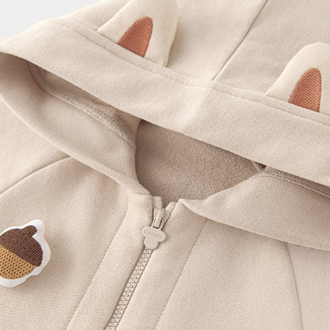 Hood with little squirrel ears and acorn patch on the oatmeal romper