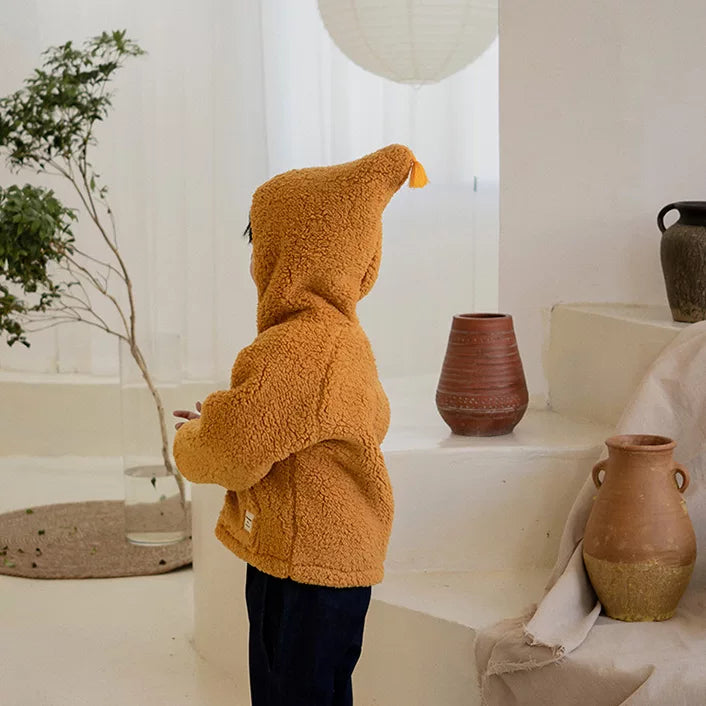 Side view of the pointed gnome hood on a mustard fleece jacket