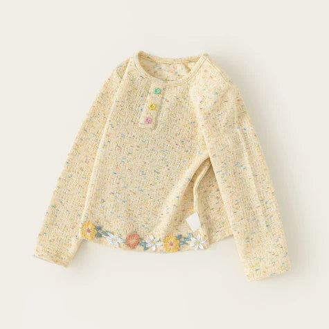 Butter yellow girls long sleeve top with flower buttons and embroidered floral hem, flat lay