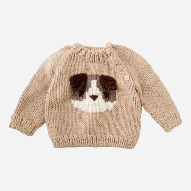 Camel chunky knit kids sweater with a puppy face motif, flat lay
