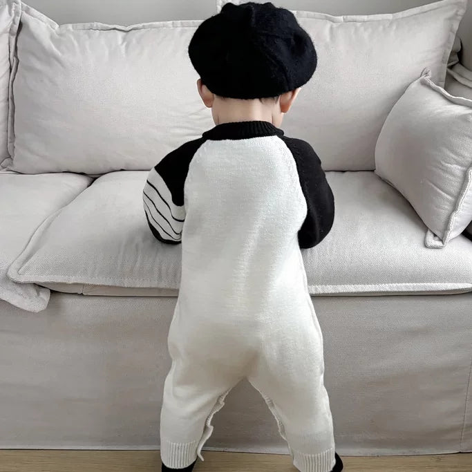 Back view of the heart knit romper with striped raglan sleeves