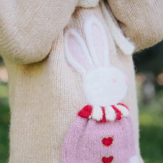 Close-up of the fluffy bunny with red striped collar and heart buttons