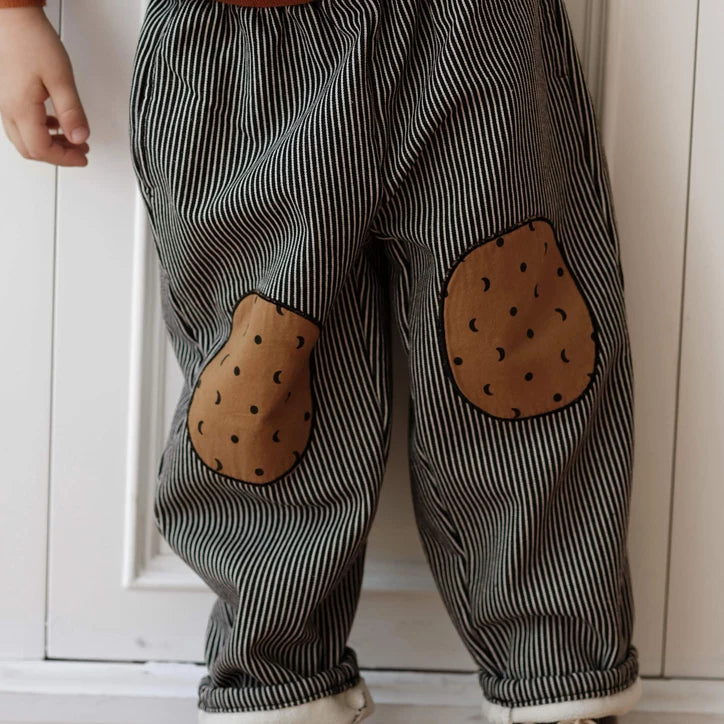 Charcoal pinstripe kids trousers with cookie knee patches and cosy fleece cuffs