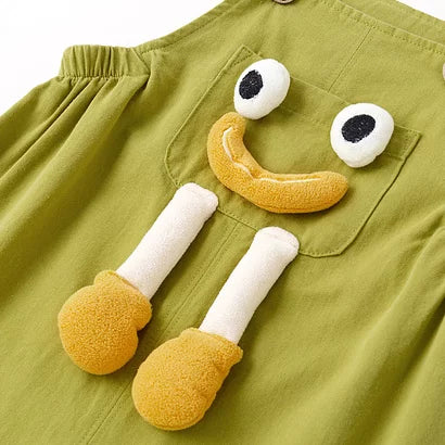 Smiley face pocket with plush 3D legs on green overalls