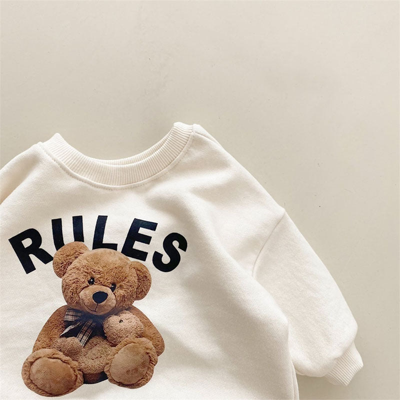 Teddy bear print graphic close-up on cream baby sweatshirt neckline