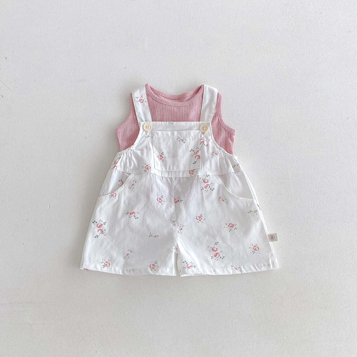 Floral overalls layered over pink ribbed tank, baby toddler outfit