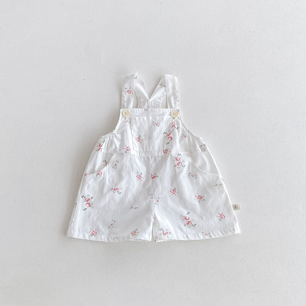White floral print baby overall shortalls with pocket detail