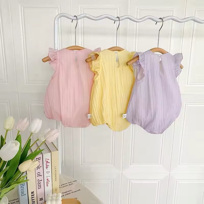 Springtime baby romper set with bunny, duck, and heart appliqués in pink, yellow, and purple