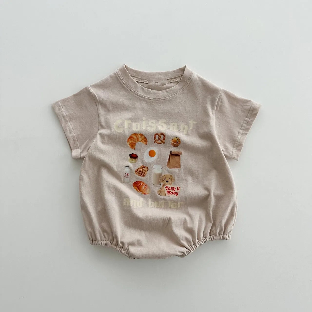 Beige baby bodysuit with croissant and butter graphic print, bubble romper