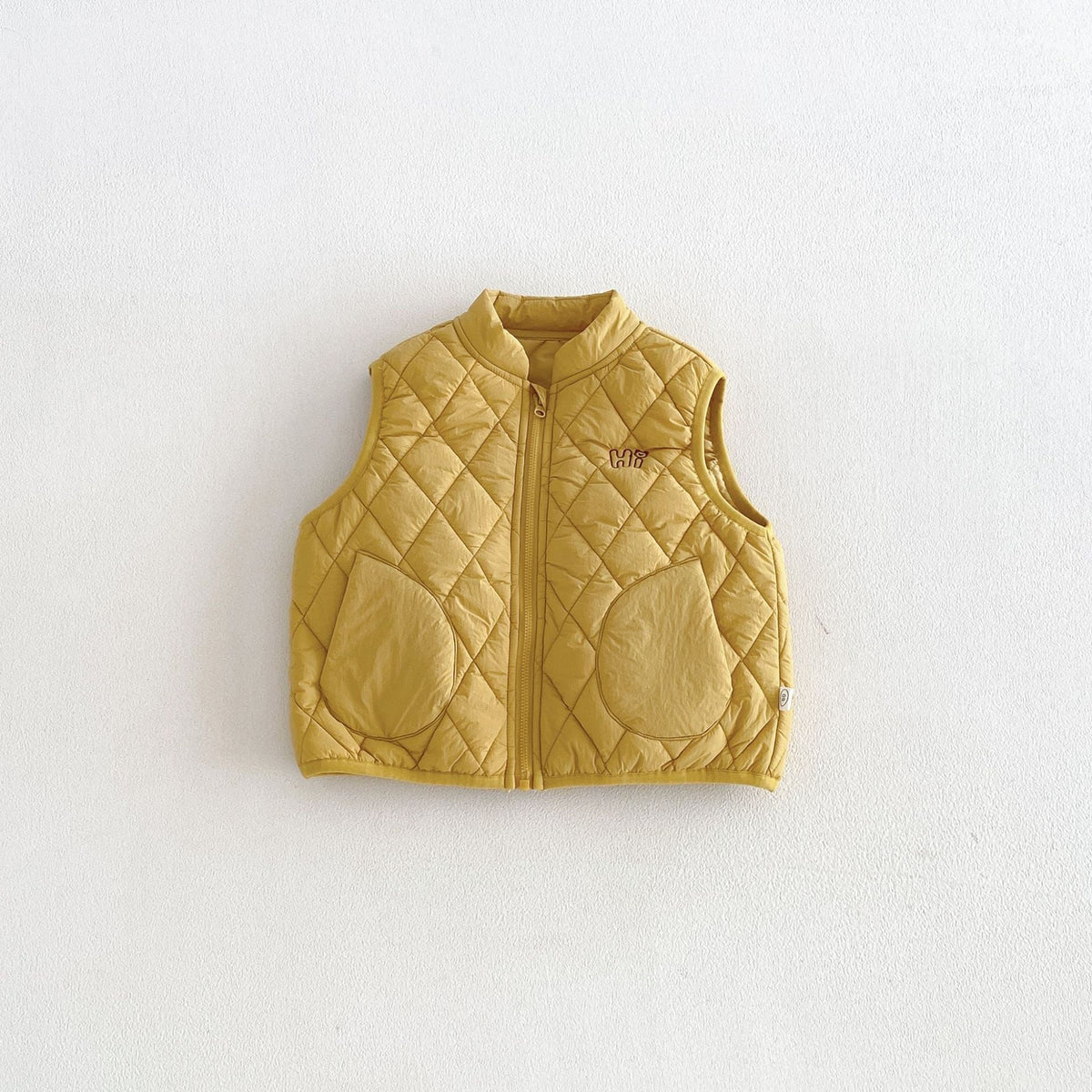 Mustard quilted puffer vest, front view