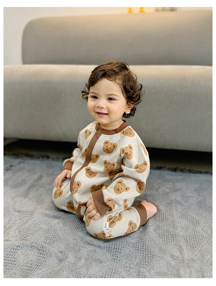Baby sitting in beige teddy bear knit jumpsuit